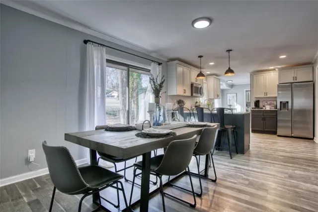 a view of a dining room with furniture window and wooden floor