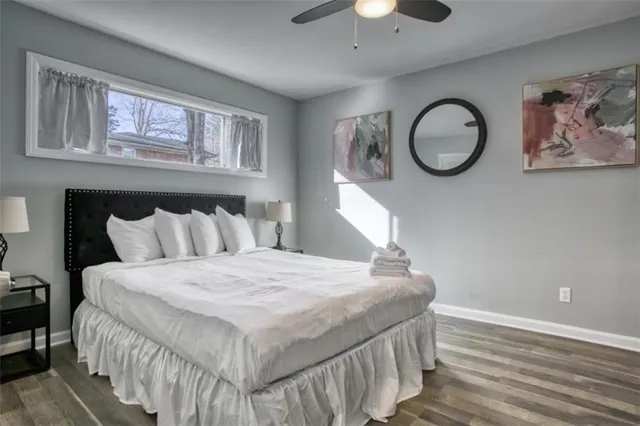 a bedroom with a large bed and a chandelier