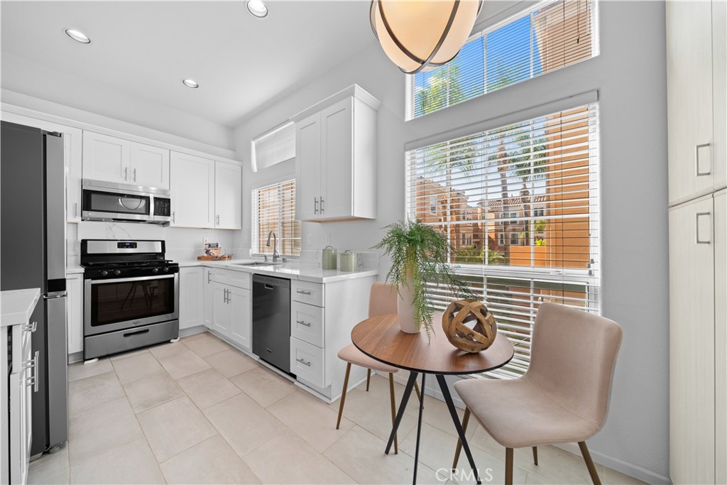 6 Arese Aisle Irvine, CA 92606 - Photo 12 of 38 a kitchen with stainless steel appliances granite countertop a stove a sink a microwave and a refrigerator