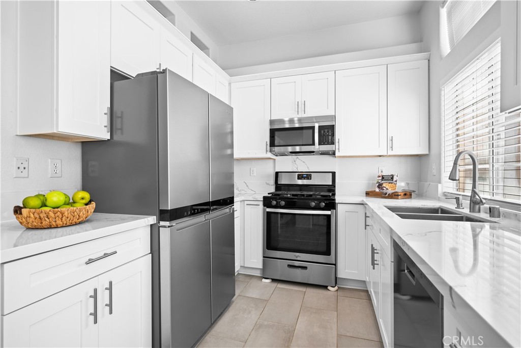 6 Arese Aisle Irvine, CA 92606 - Photo 13 of 38 a kitchen with stainless steel appliances a stove a sink and a refrigerator