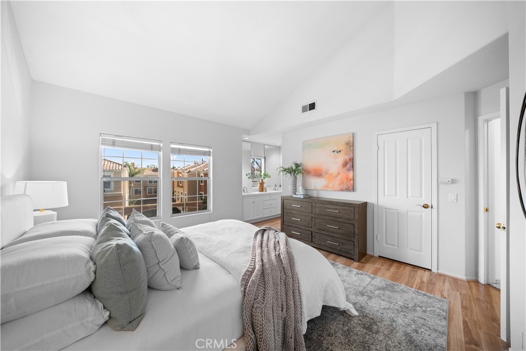 6 Arese Aisle Irvine, CA 92606 - Photo 18 of 38 a spacious bedroom with a bed and glass window