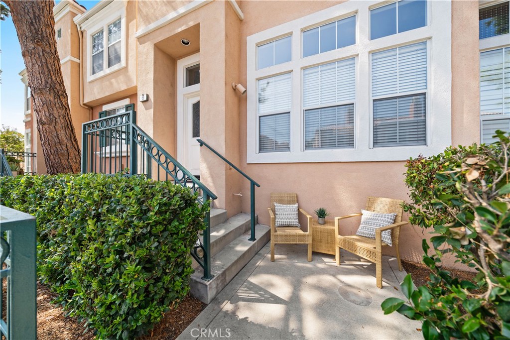 6 Arese Aisle Irvine, CA 92606 - Photo 2 of 38 a view of a building with a bench and potted plants