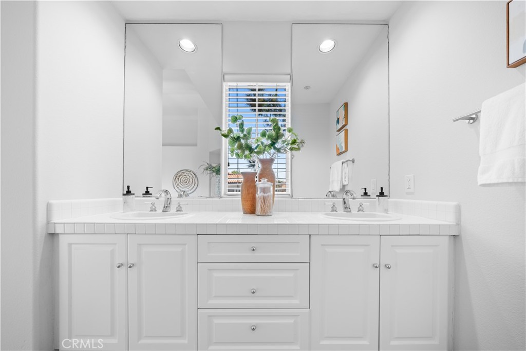 6 Arese Aisle Irvine, CA 92606 - Photo 22 of 38 a bathroom with double sink a mirror and a shower