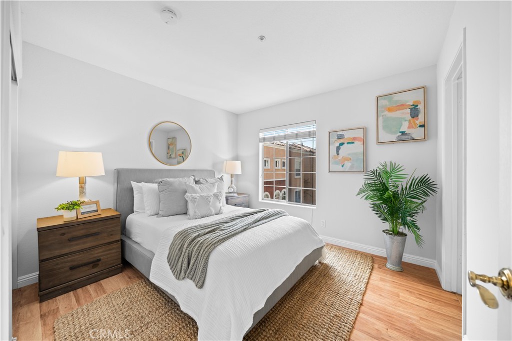 6 Arese Aisle Irvine, CA 92606 - Photo 27 of 38 a bedroom with a large bed and a potted plant