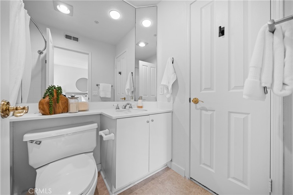 6 Arese Aisle Irvine, CA 92606 - Photo 29 of 38 a bathroom with a toilet sink and mirror