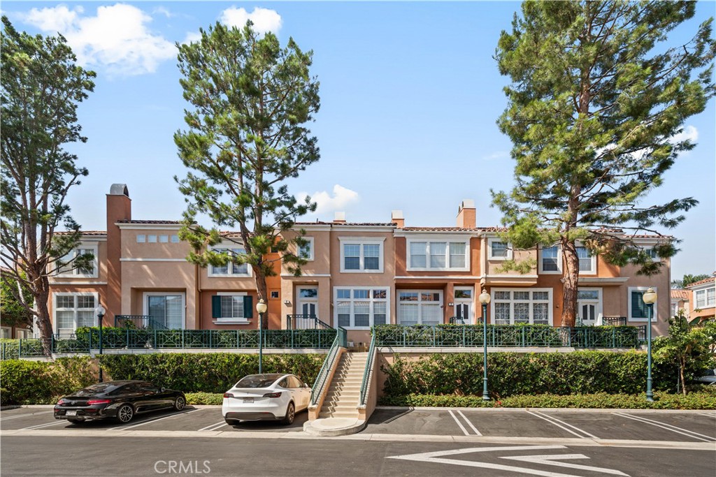 6 Arese Aisle Irvine, CA 92606 - Photo 33 of 38 a car parked in front of a brick house