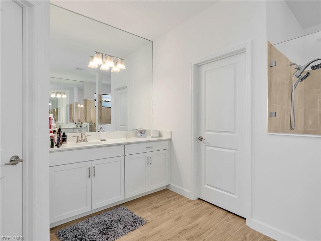 18278 Ridgeline Drive Estero, FL 33928 - Photo 20 of 45 a bathroom with a double vanity sink and a mirror