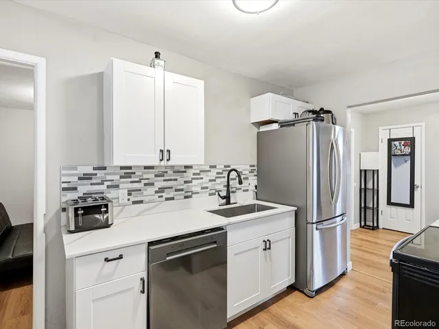 a kitchen with a sink stove and refrigerator