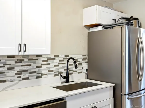 a view of a kitchen with a sink and cabinets
