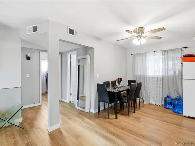 a view of a dining room with furniture and chandelier
