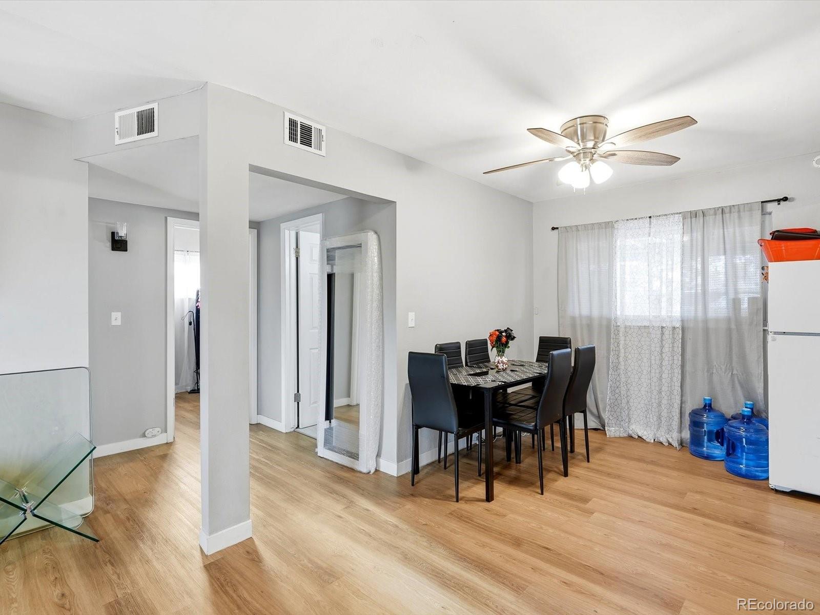 1883 South Perry Way Denver, CO 80219 - Photo 16 of 36 a view of a dining room with furniture and chandelier