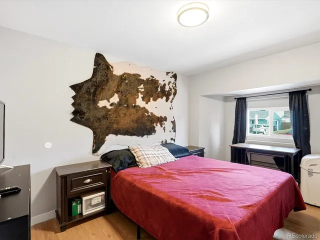 a bedroom with a bed and a chandelier