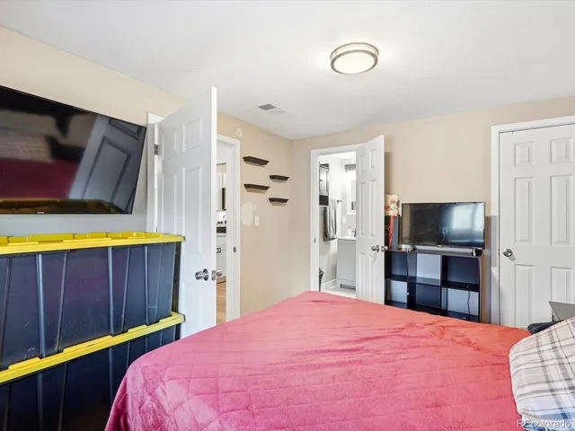 a bedroom with a bed and a television