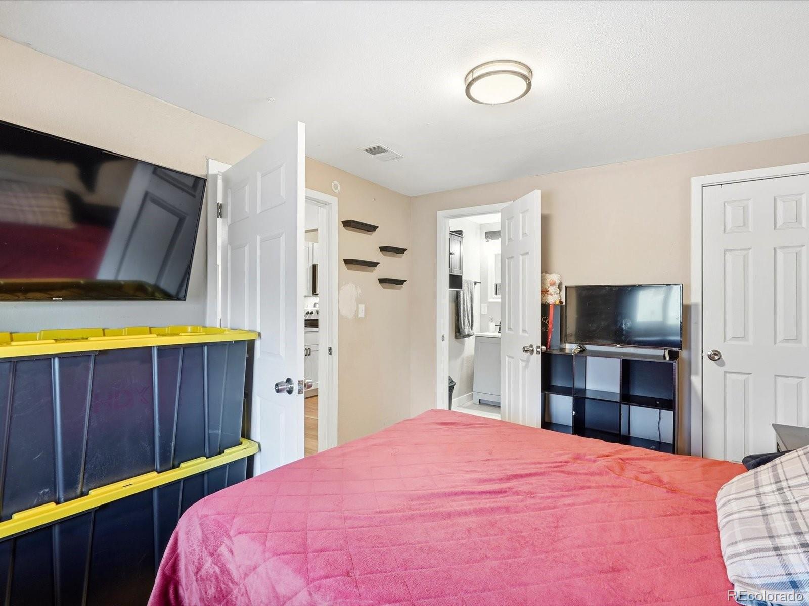 1883 South Perry Way Denver, CO 80219 - Photo 23 of 36 a bedroom with a bed and a television