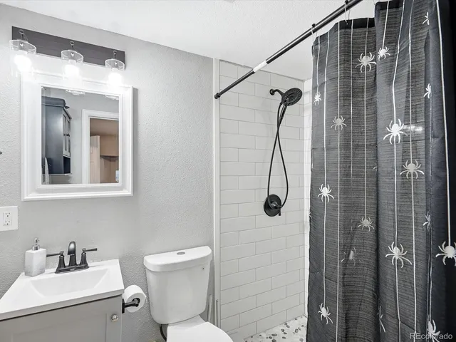a bathroom with a toilet sink and shower