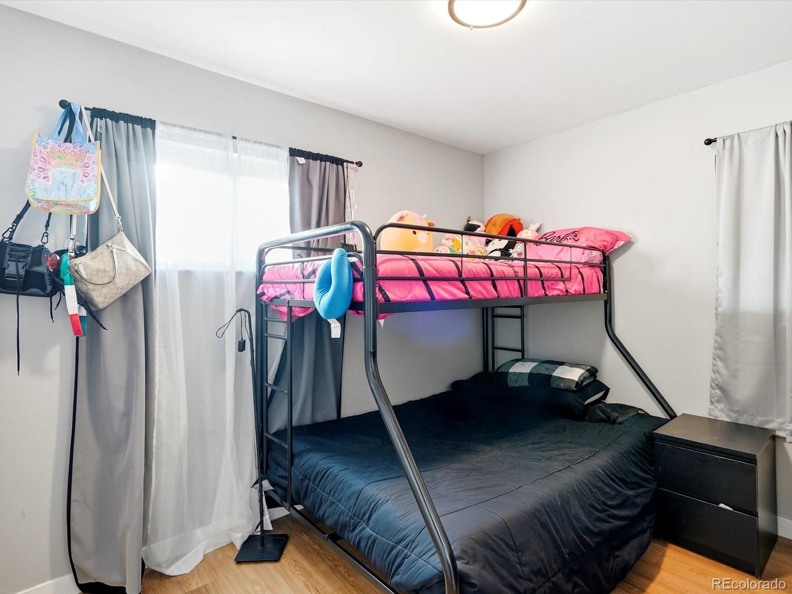 1883 South Perry Way Denver, CO 80219 - Photo 26 of 36 a bedroom with a bed and a table