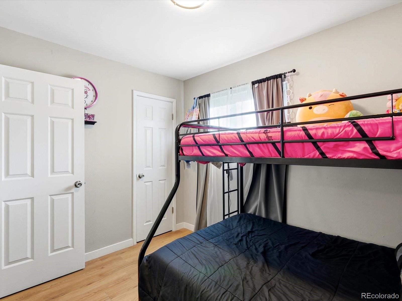 1883 South Perry Way Denver, CO 80219 - Photo 27 of 36 a bedroom with a bed and window