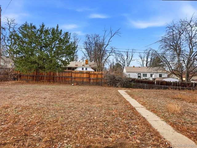 a front view of house with yard and car parked