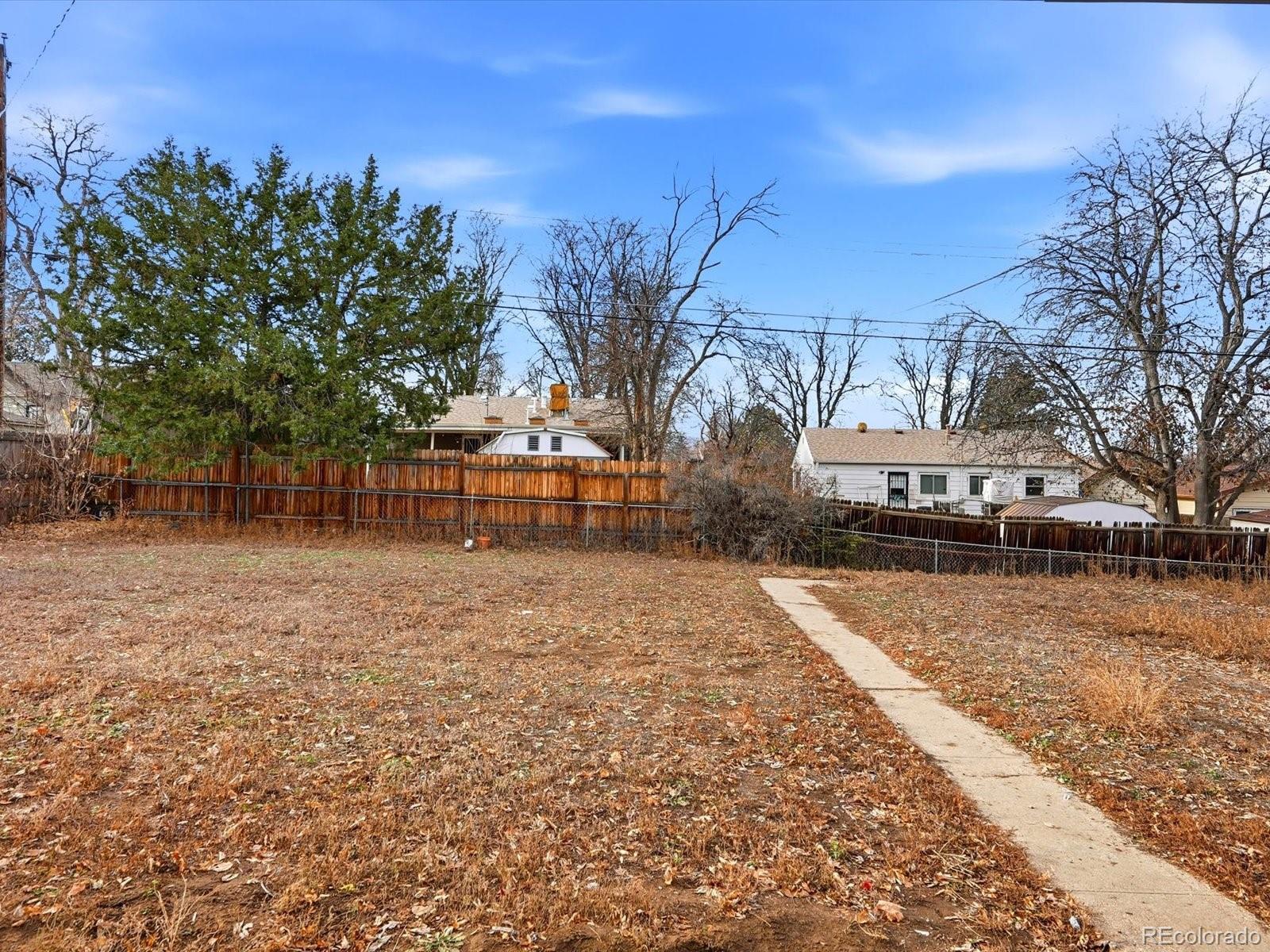 1883 South Perry Way Denver, CO 80219 - Photo 33 of 36 a view of a yard with a house