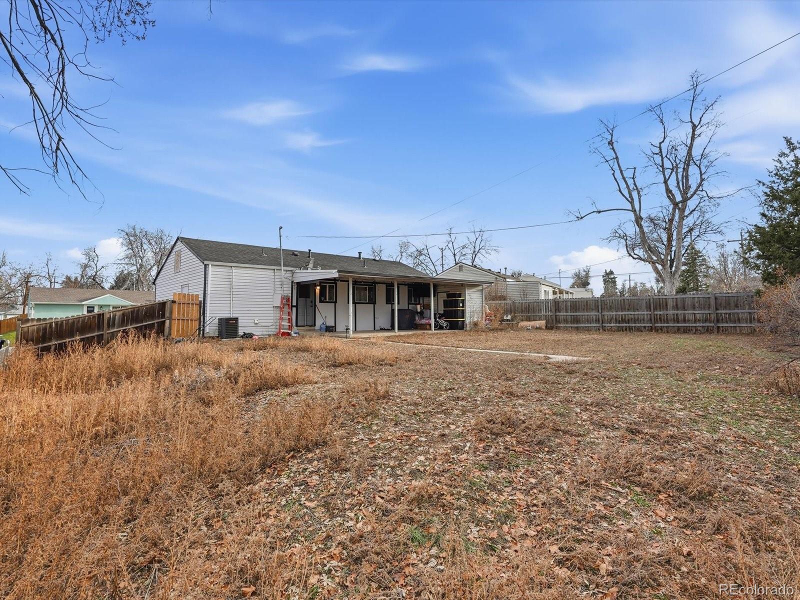 1883 South Perry Way Denver, CO 80219 - Photo 34 of 36 a front view of house with yard and car parked