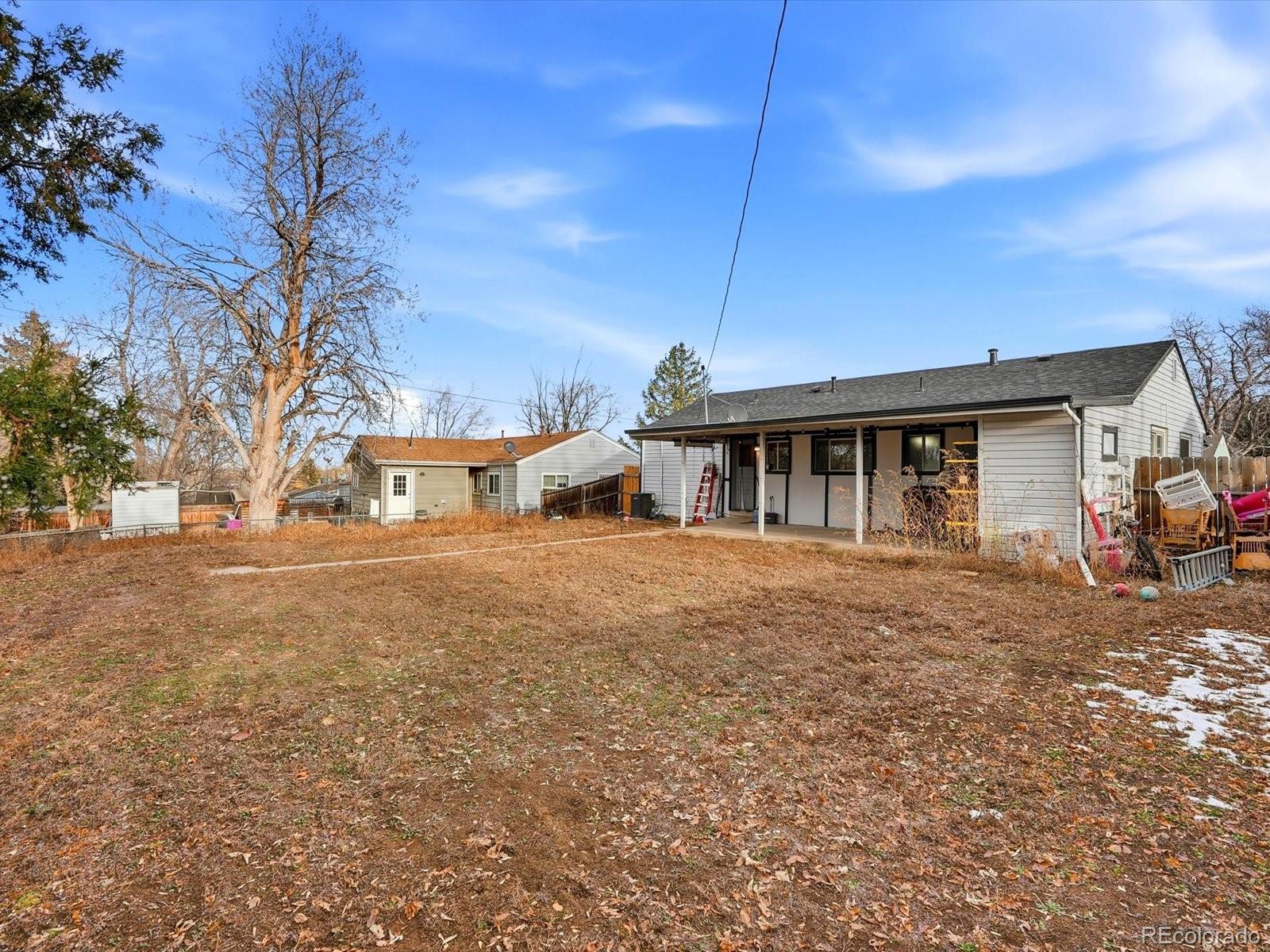 1883 South Perry Way Denver, CO 80219 - Photo 36 of 36 a front view of a house with a garden