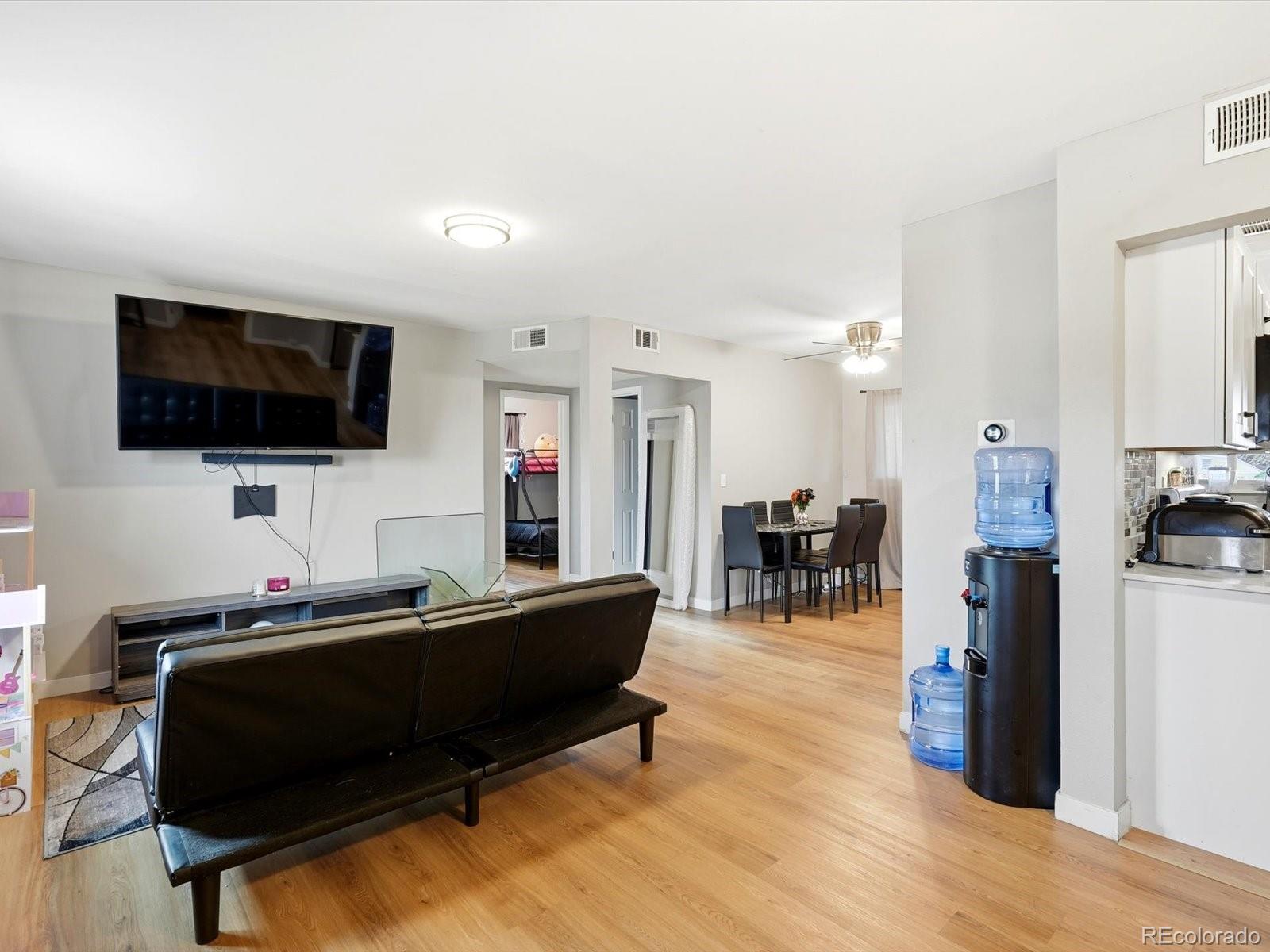 1883 South Perry Way Denver, CO 80219 - Photo 5 of 36 a living room with furniture and a flat screen tv