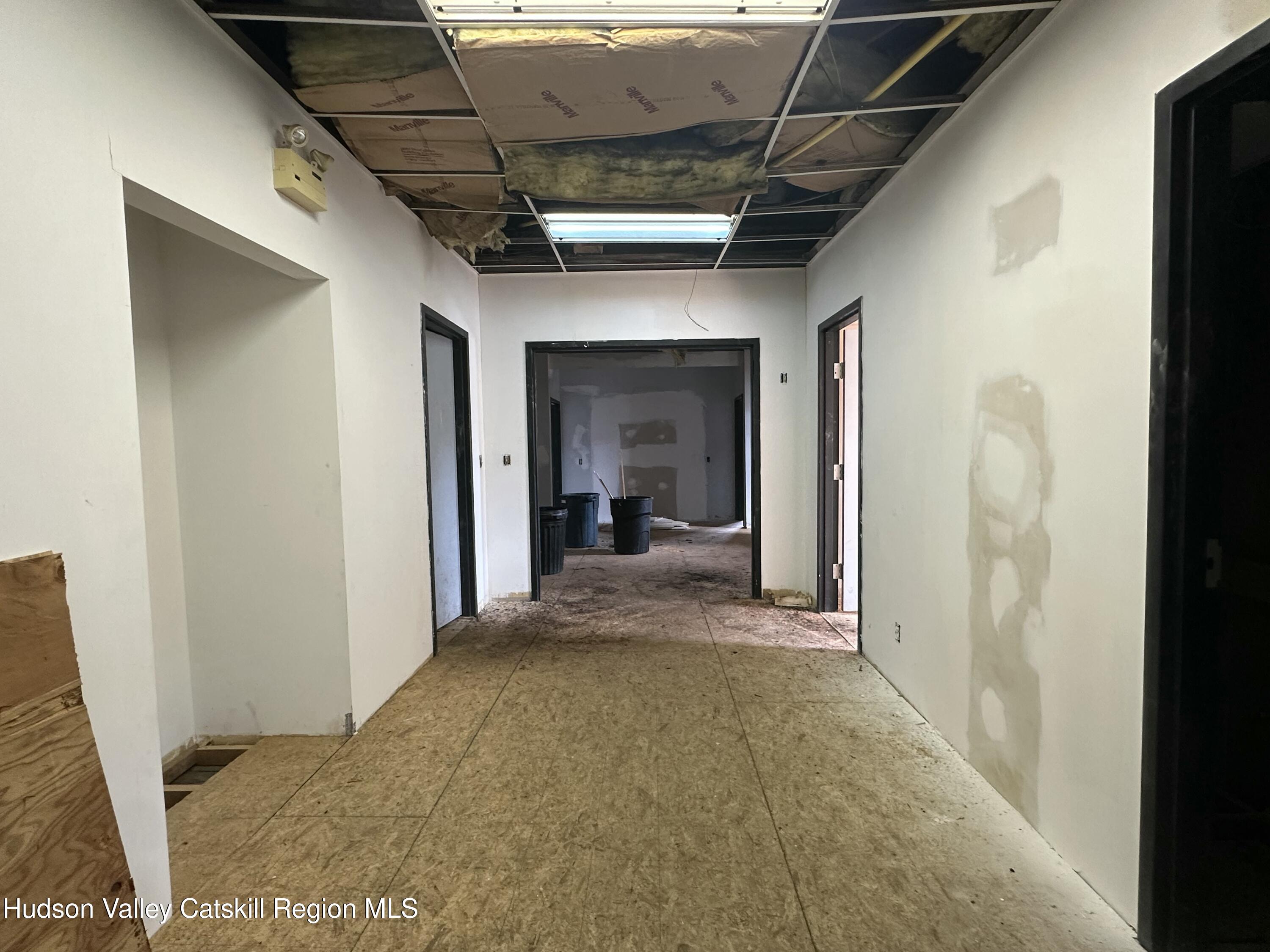 447 Main Street, Unit 477 Catskill, NY 12414 - Photo 22 of 34 a view of a hallway with wooden floor and a bathroom