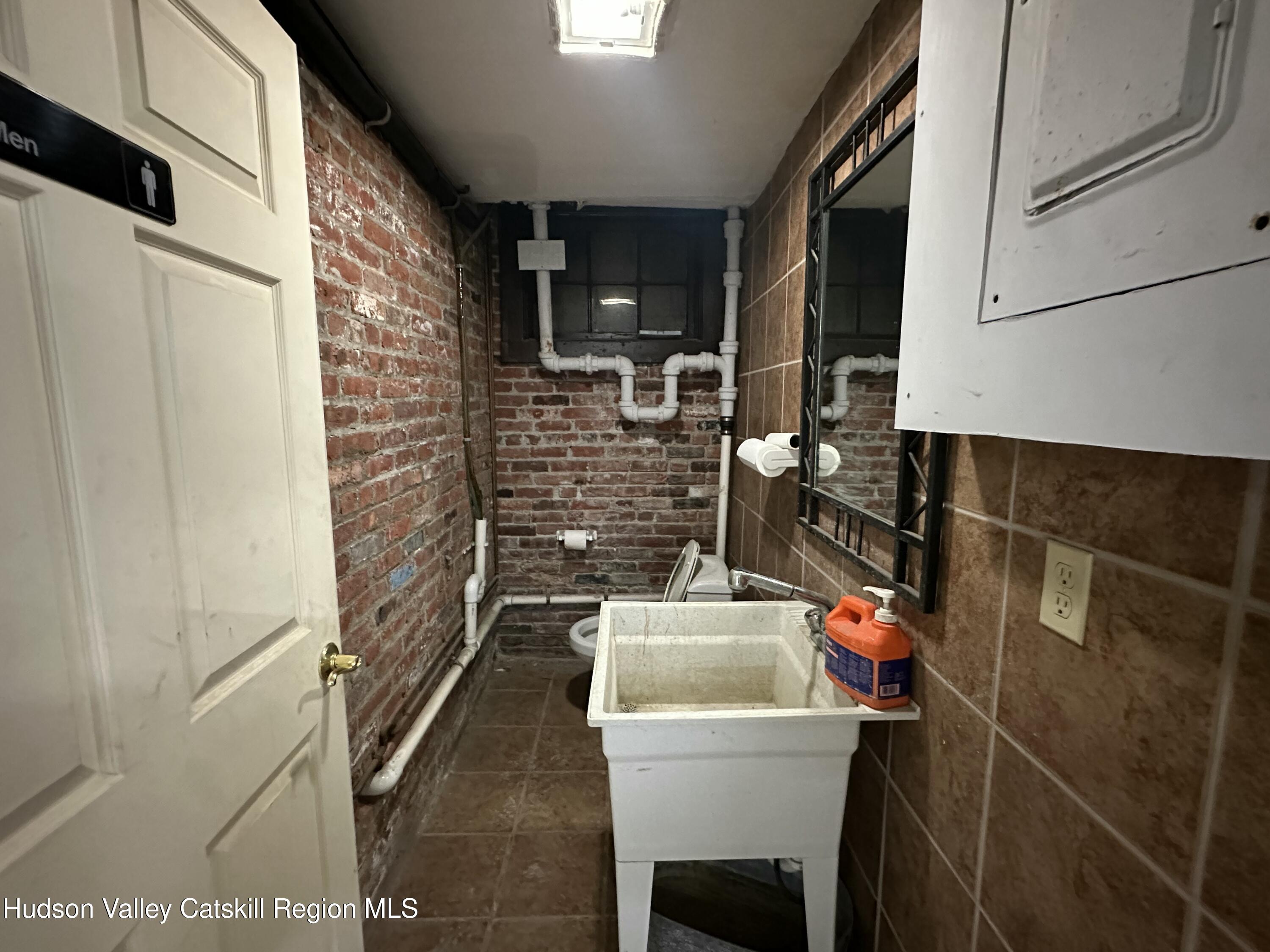 447 Main Street, Unit 477 Catskill, NY 12414 - Photo 28 of 34 a bathroom with a sink and a mirror