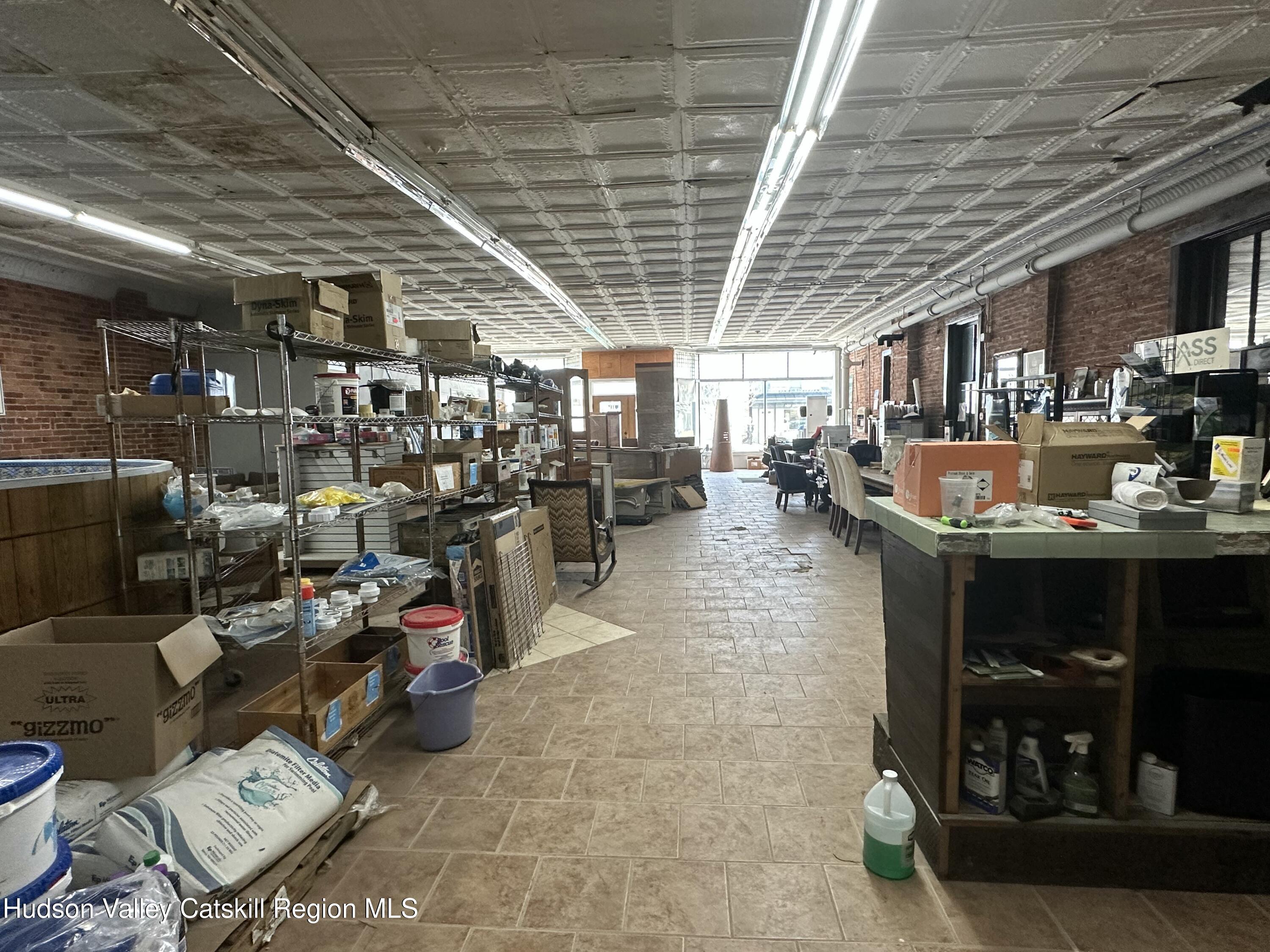 447 Main Street, Unit 477 Catskill, NY 12414 - Photo 9 of 34 a living room with lots of furniture and clutter