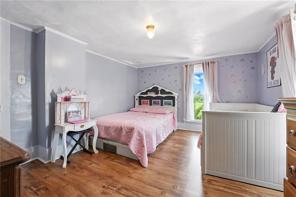 246 Lyons Road Stoneboro, PA 16153 - Photo 15 of 40 a bedroom with a bed and wooden floor