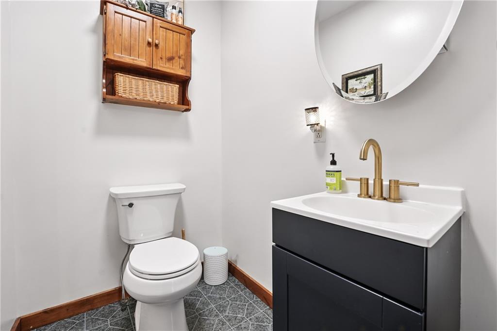 246 Lyons Road Stoneboro, PA 16153 - Photo 19 of 40 a bathroom with a sink a toilet and mirror