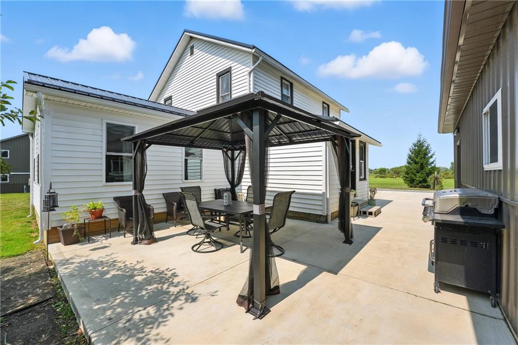 246 Lyons Road Stoneboro, PA 16153 - Photo 3 of 40 a view of a patio with table and chairs with wooden floor and fence