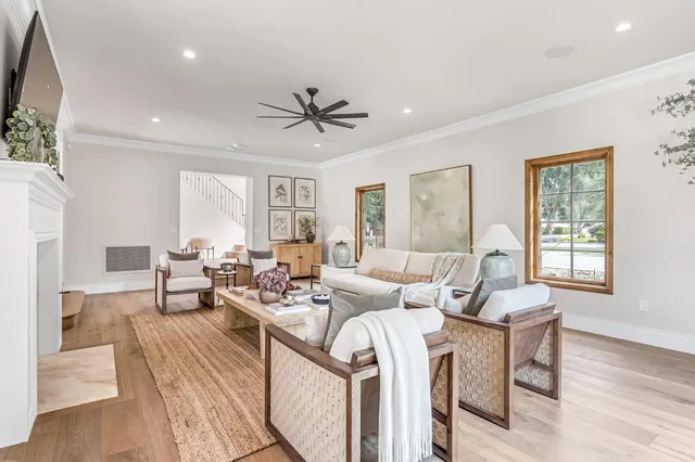 a living room with furniture a fireplace and a wooden floor