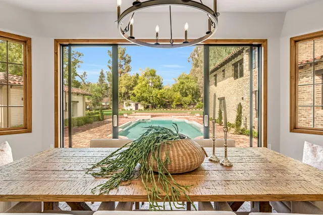 a kitchen with kitchen island a large counter top space a sink stainless steel appliances and cabinets