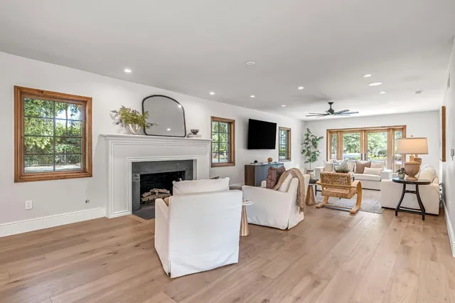 a large kitchen with kitchen island a stove a sink a dining table and chairs