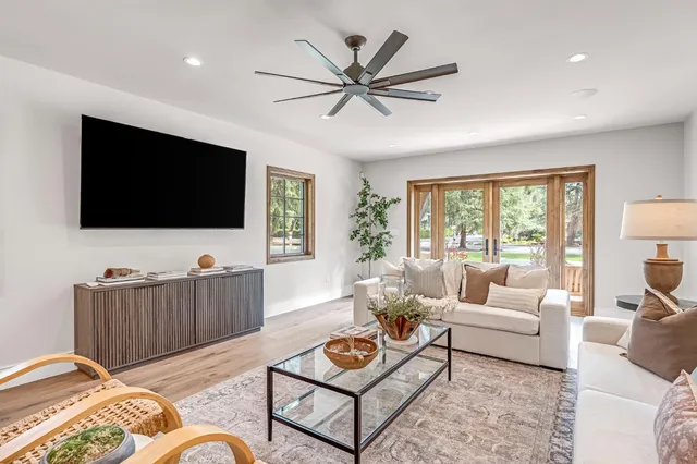 a dining room with furniture a chandelier and wooden floor