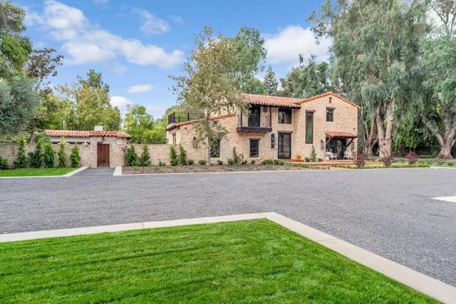 a bedroom with a bed and a window with chair