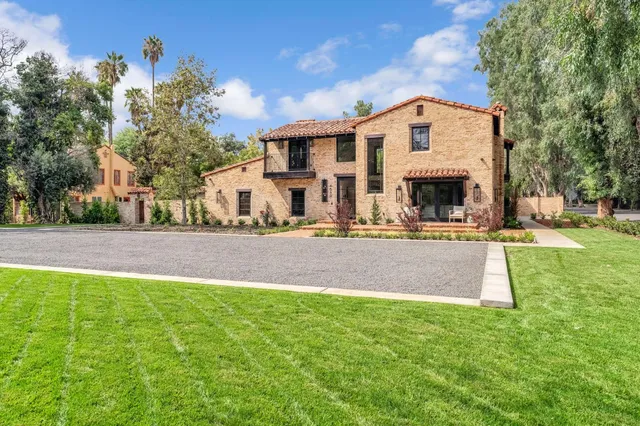 a living room with furniture a flat screen tv and a window