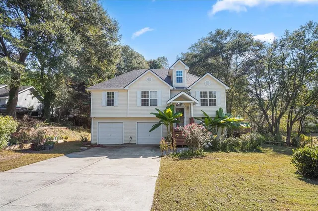 a front view of a house with garden