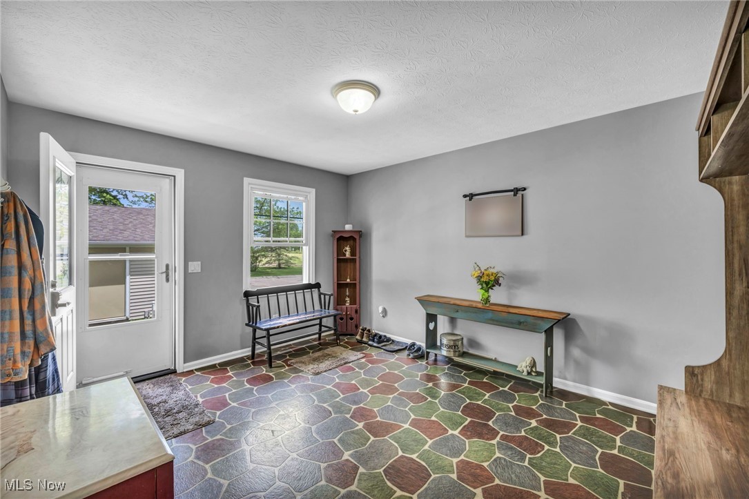 7662 State Road Wadsworth, OH 44281 - Photo 21 of 49 Foyer featuring stone flooring, baseboards, and a textured ceiling