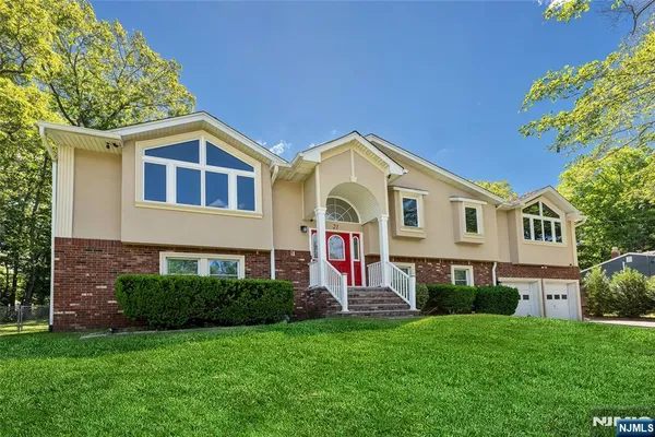 a front view of a house with a yard