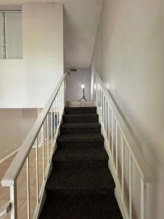 a view of an empty room and window and fireplace