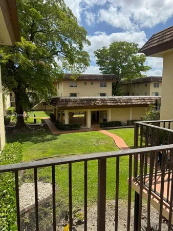 a view of a balcony with a small yard