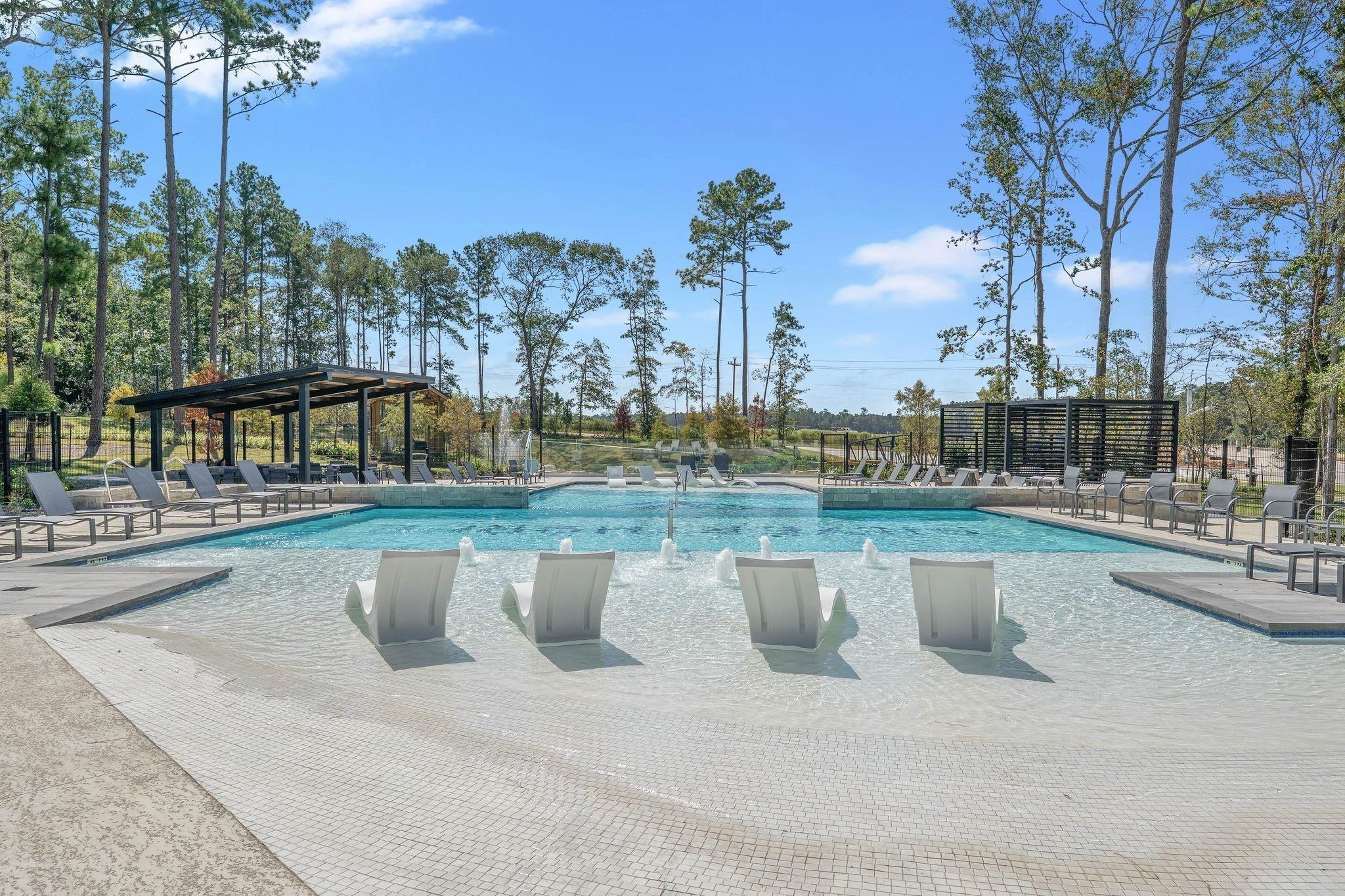 925 Sutherland Falls Street Conroe, TX 77303 - Photo 3 of 9 a view of a swimming pool with a patio