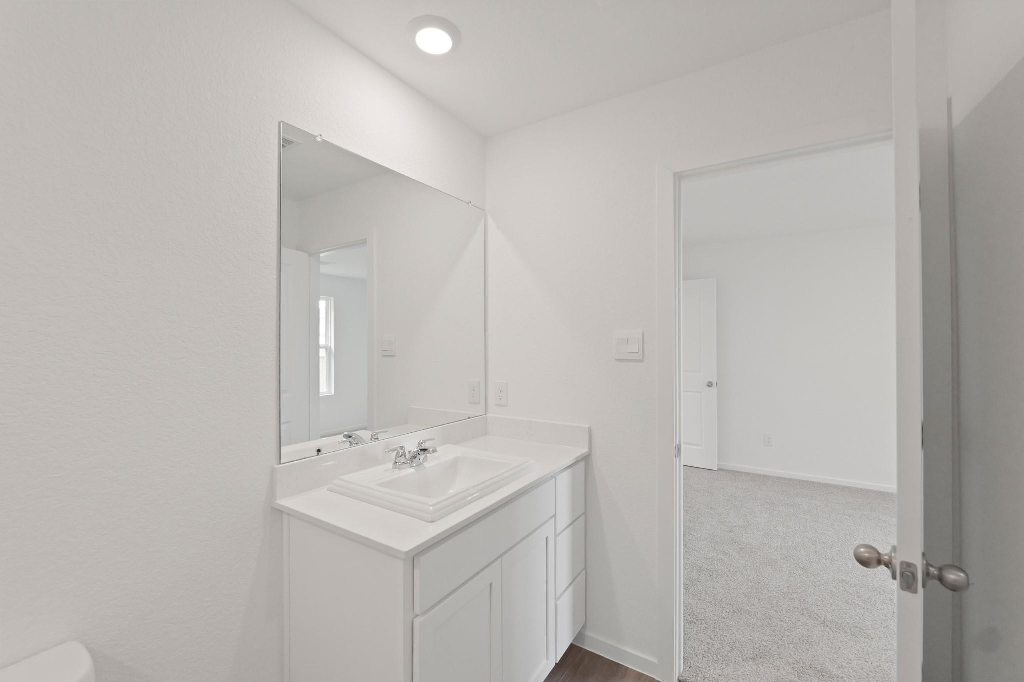 925 Sutherland Falls Street Conroe, TX 77303 - Photo 5 of 9 a bathroom with a sink and a mirror