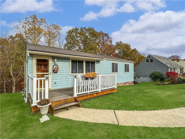 a view of a house with a yard and deck