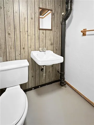 a bathroom with a sink a toilet and mirror