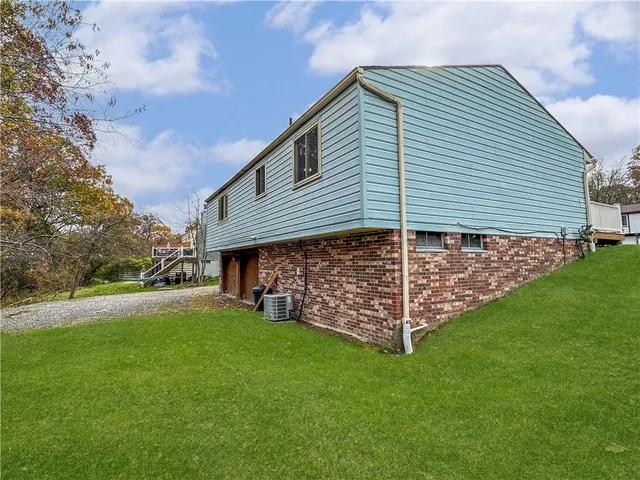 a view of a house with a yard and porch