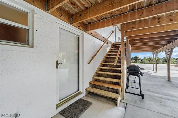 a view of balcony with wooden floor and outdoor seating