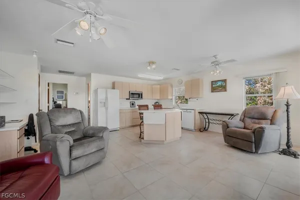 a living room with furniture and kitchen view